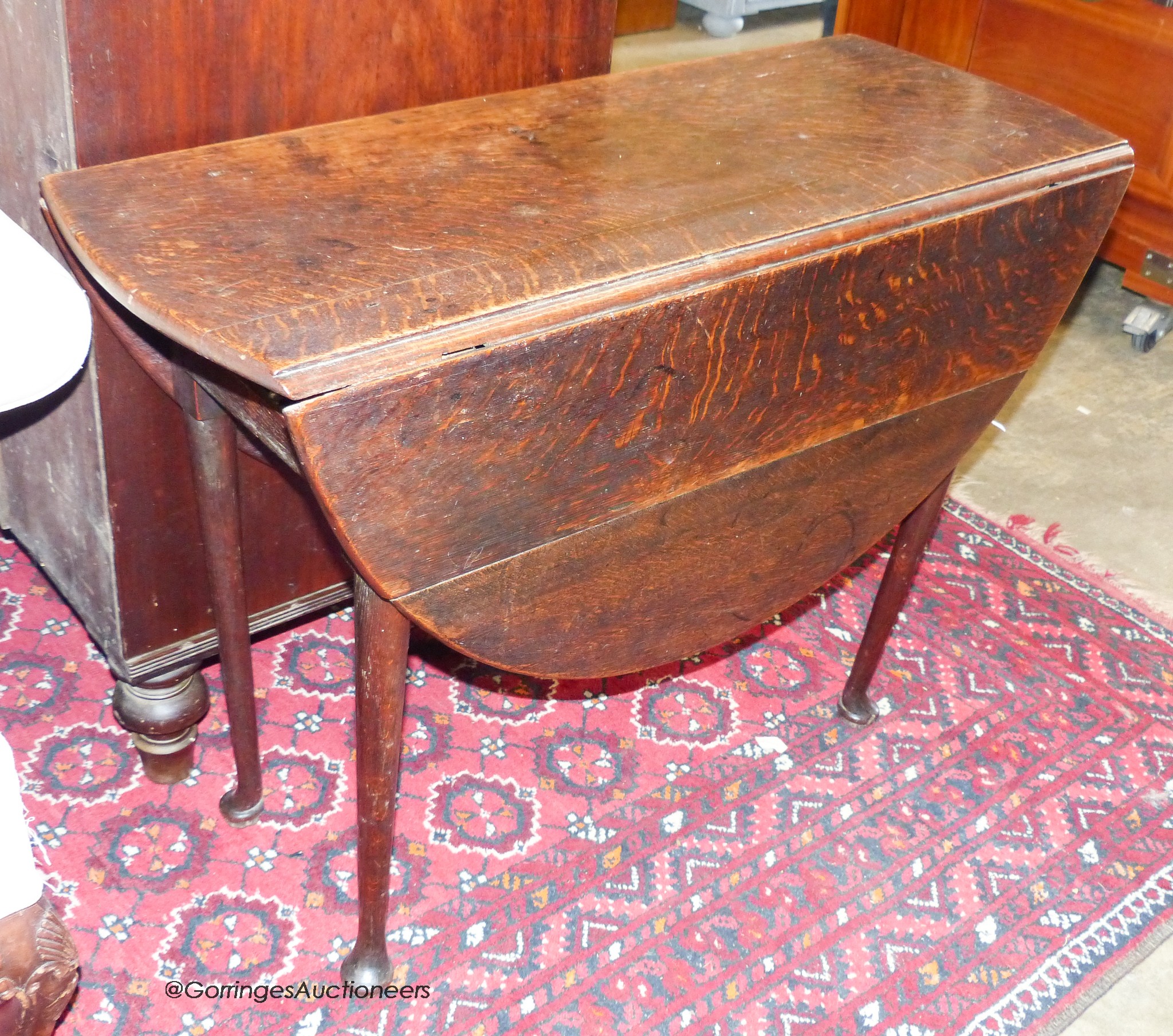 An 18th century oak drop leaf pad foot table, width 94cm, depth 38cm, height 68cm